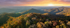 Wooded sunset hills of the Appalachian Mountains in North Carolina with lush and evergreen forest trees in the fall season. Beauty of autumnal nature.