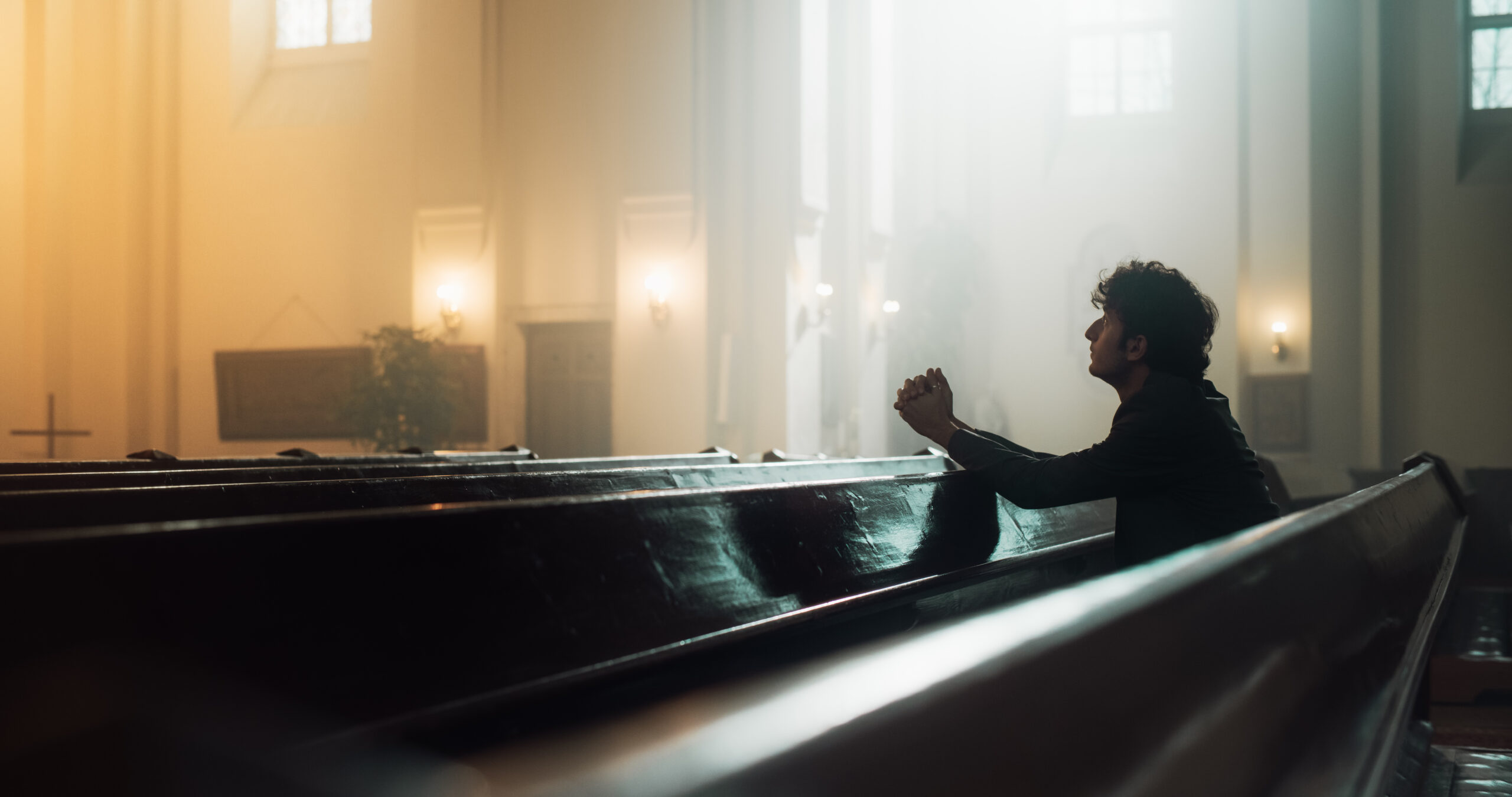 In A Grand Old Church, A Devout Christian Sits, finding Comfort in Faith. Contemplating Life, Seeking Moral Guidance. Sacred Space is Filled With Religious Atmosphere, Providing Solace To The Faithful